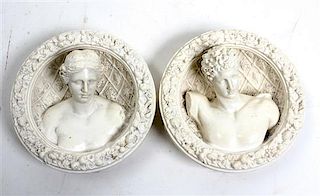 * A Pair of Composite Figural Wall Plaques Diameter 5 3/4 inches.