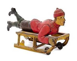 * A Hess-Roller Painted Tin Friction Toy Length overall 6 1/2 inches.