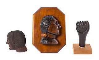 Manly L. Lundberg, (American, 1908-1973), a set of two carved profiles and a carved fist