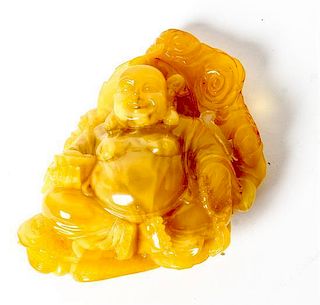 * A Carved Amber Figure of Laughing Buddha, Budai Height 3 3/4 inches.