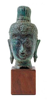 * A Southeast Asian Bronze Head of a Deity Height 6 inches.
