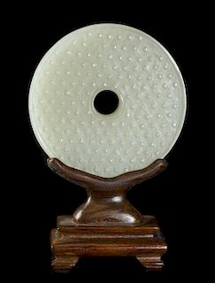 A Carved White Jade Bi, Diameter 2 1/2 inches.