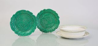EIGHT GREEN MAJOLICA BRAMELD GREEN GLAZED POTTERY TIERED-LEAF PLATES AND A CREAMWARE BASKET WITH UNDERPLATE