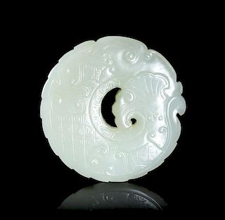 A Carved White Jade Circular Plaque, Diameter 2 1/4 inches.