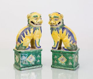 PAIR OF CHINESE YELLOW, GREEN AND BLUE GLAZED BUDDHISTIC LIONS