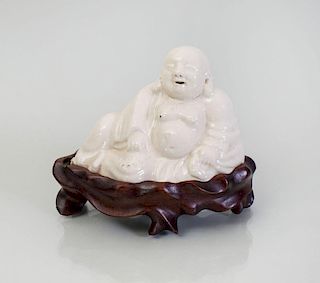 CHINESE WHITE GLAZED PORCELAIN FIGURE OF A RECLINING BUDDHA