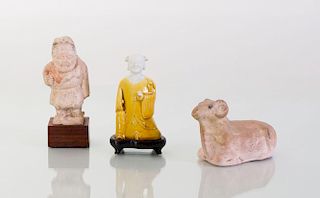 TWO CHINESE POTTERY FIGURES AND A CHINESE PORCELAIN YELLOW GLAZED FIGURAL JOSS STICK HOLDER