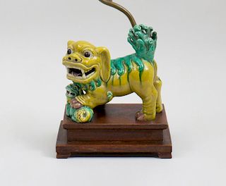 CHINESE YELLOW AND GREEN GLAZED MODEL OF A BUDDHISTIC LION MOUNTED AS A LAMP
