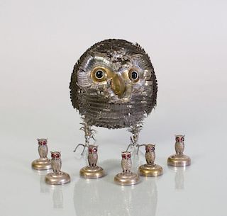 SET OF SEVEN SILVERED-METAL OWL-FORM PLACE CARD HOLDERS AND AN OWL-FORM SILVERED-METAL TABLE ORNAMENT