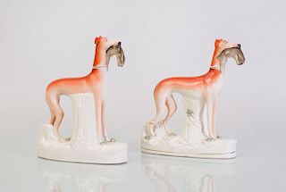 PAIR OF STAFFORDSHIRE POTTERY MODELS OF HOUNDS