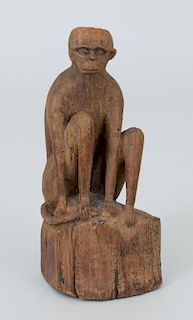 CARVED WOOD FIGURE OF A SEATED MONKEY