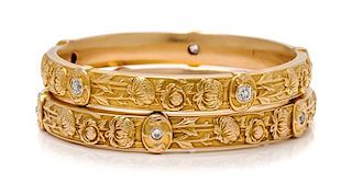 * A Collection of Art Nouveau Yellow Gold and Diamond Chrysanthemum Motif Bangle Bracelets, 28.70 dwts.