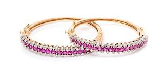 * A Pair of 14 Karat Bicolor Gold, Pink Sapphire and Diamond Bangle Bracelets, 27.30 dwts.