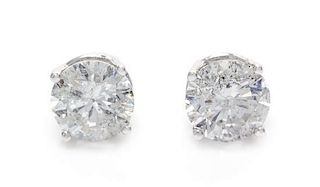 A Pair of 14 Karat White Gold and Diamond Stud Earrings, 1.10 dwts.