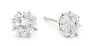 A Pair 14 Karat White Gold and Diamond Stud Earrings, 0.90 dwts.