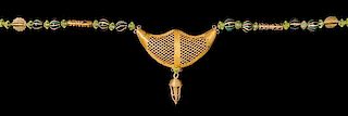 * An Akan Gold Alloy, Metal Alloy, Glass Bead and Crescent Pendant/Necklace, CÃ™te d'Ivoire/Ghana, strung with numerous bi