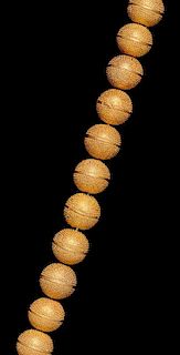 * An Akan Gold Alloy Bead Necklace, CÃ™te d'Ivoire/Ghana, strung with 22 textured beads.