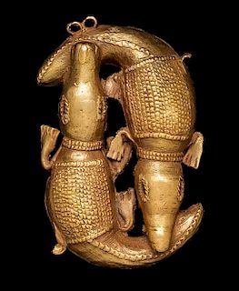 * An Akan Gold Alloy Double Crocodile Pendant, CÃ™te d'Ivoire/Ghana,