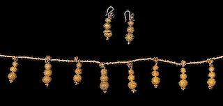 * An Akan Gold Alloy Demi-Parure, CÃ™te d'Ivoire/Ghana, consisting of a necklace strung with numerous tubular beads and su