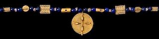 * An Akan Metal Alloy, Glass and Birds on a Disk Pendant/Necklace, CÃ™te d'Ivoire/Ghana, strung with numerous round blue g