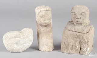 Three carved stone figures