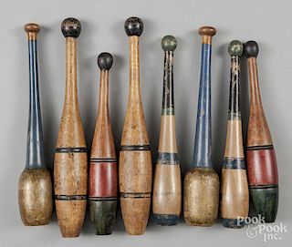 Four pairs of painted Indian clubs