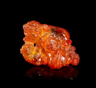 A Carved Amber Toggle, Width 2 inches.