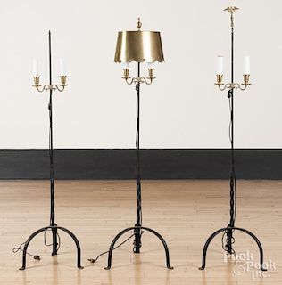 Three iron and brass floor lamps.