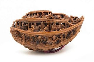 A Carved Peach Pit Boat, Width 1 3/4 inches.
