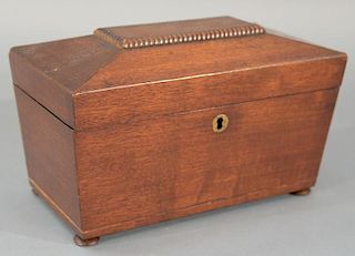 Mahogany tea box on suppressed feet, interior with two compartments and glass jar.   height 6 1/2 inches, width 11 1/4 inches