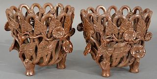 Pair of brown stoneware openwork jardiniers mounted with three dimensional flowers on three feet each (one with missing flowe