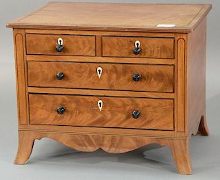 Diminutive mahogany chest having two over two drawer, set on flared French feet. 
height 13 1/2 inches, width 16 inches, dept