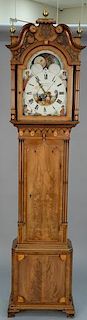 Mahogany tall case clock having broken arch top over tombstone glass on panel inlaid case set on ogee feet, moon phase metal