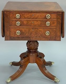 Federal mahogany work table with drop leaves and burlwood top with three drawers set on acanthus carved pedestal on four down