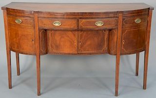 Federal mahogany sideboard having shaped bowed front with two center drawers over two doors and flanked by two doors. 
height