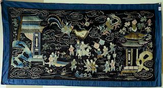 Large Chinese embroidered silk panel, black ground having courtyard with boys motif, scholar on flying dragon amongst clouds,