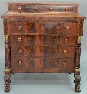 Federal mahogany two over four drawer chest in two parts having oak leaf columns with bronze mounts, set on carved paw feet,