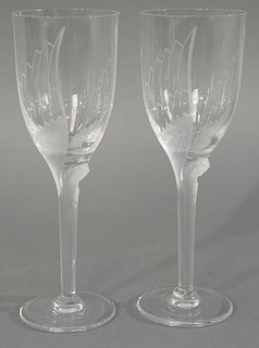 Set of fifteen Lalique champagne flutes having stemmed base with frosted winged angel. 
height 8 inches 
Provenance: From the