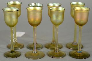 Set of eight Tiffany Favrile gold iridescent stemmed cordial glasses, incised L.C.T. on bottom. 
height 4 1/2 inches