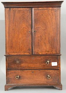 Miniature mahogany linen press with two doors over two drawers on bracket feet, early 19th century. 
height 24 inches, width
