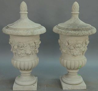 Pair of cement urns in two parts.   height 49 inches, diameter 24 inches  Provenance: Property from the Estate of Frank Perro