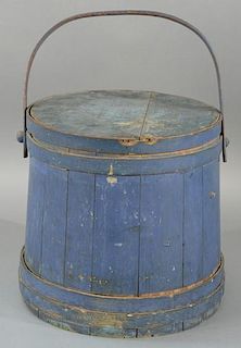 Primitive blue painted firkin with swing bentwood handle and three straps. 
height 14 1/4 inches, diameter 14 1/4 inches
Prov