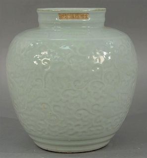 Celadon glazed vase having incised scrolling vines and dragon decoration, drilled base, top rim signed in unglazed rectangle,