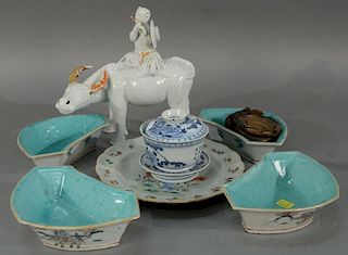 Tray lot of Oriental porcelain items to include blanc de chine buffalo, set of four famille rose dishes, a blue and white cup