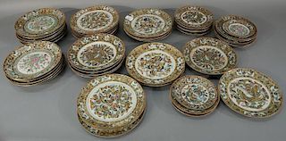 Assembled set of famille rose various size plates, fifty total pieces, decorated with butterflies.   diameters 5 3/4, 8, and