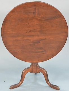 Cherry tip table with round top on turned shaft set on tripod base. 
height 27 1/2 inches, diameter 33 inches