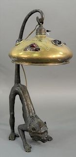 Bronze monkey desk lamp in crouched position with glass eyes having curved tail suspending hanging light with brass shade set