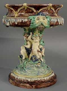 Large Majolica figural compote having putti figures on fish base. 
height 13 3/4 inches, top diameter 10 1/2 inches