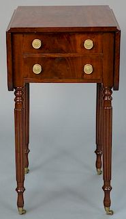 Sheraton mahogany drop leaf stand with two drawers on turned and fluted legs ending in brass capped feet. 
height 28 inches,