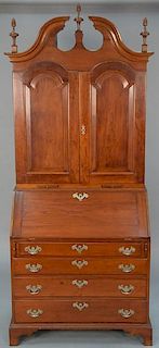 Chippendale cherry secretary bookcase/desk in two parts, upper portion with three carved finials over scrolled pediment over